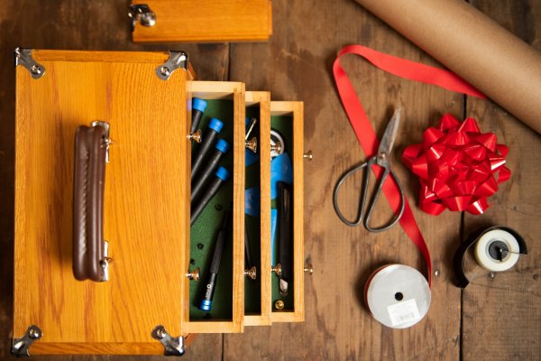 oak toolbox from above, with screwdrivers and gift wrapping