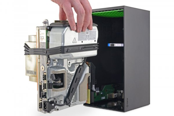 Hand removing the main components of an Xbox Series X